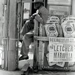 Man outside a liquor store in Oakland, California, 1962