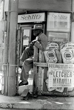 Man outside a liquor store in Oakland, California, 1962